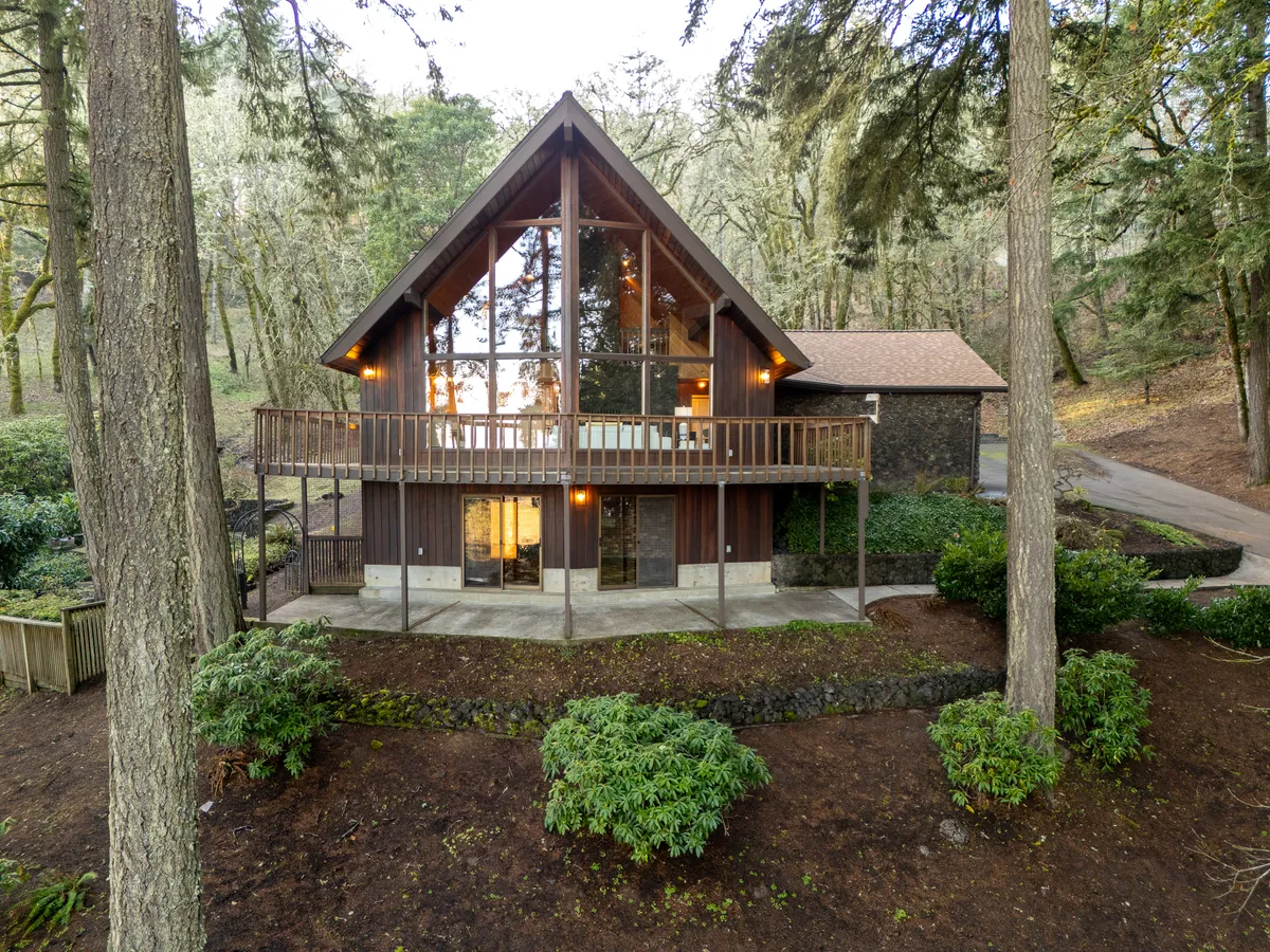 An A-frame home among the firs in the Crescent Valley area of Corvallis, Oregon, from one of Marty Fulford's listings