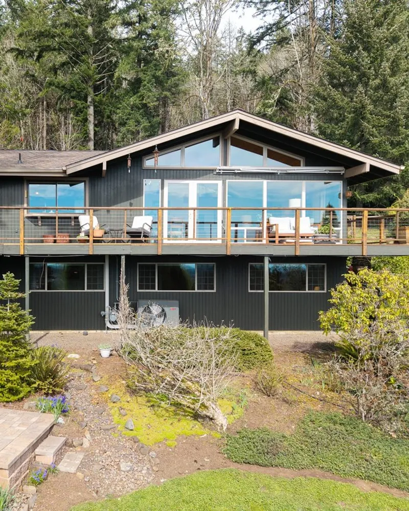 A mid-century Corvallis home with a wraparound deck backing onto the firs, from one of Marty Fulford's listings